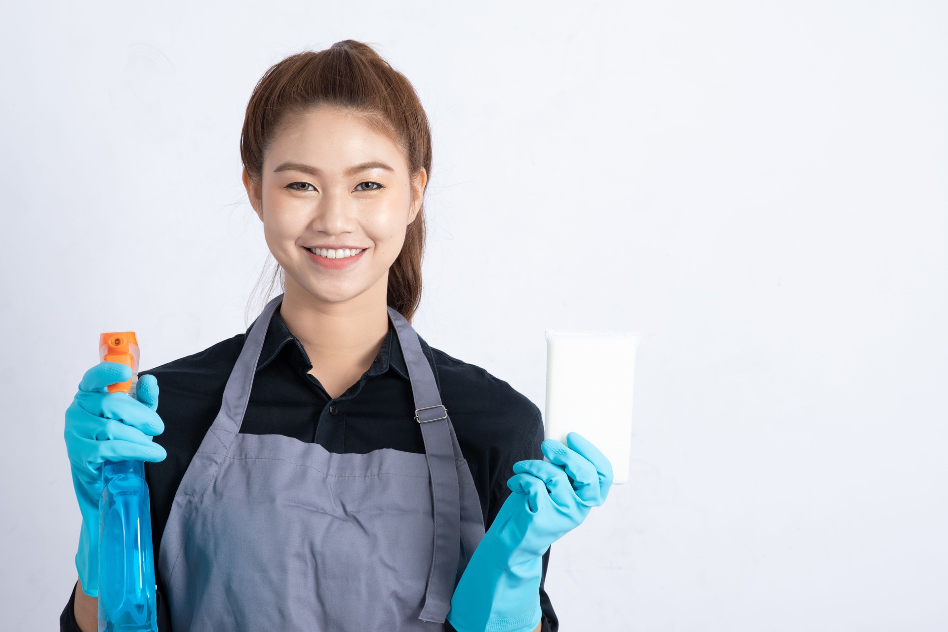 Beautiful Attractive Asian Maid Woman smile and holding cleaner spray and sponge feeling happiness and confident,Isolated on white background,Cleaning Service Concept